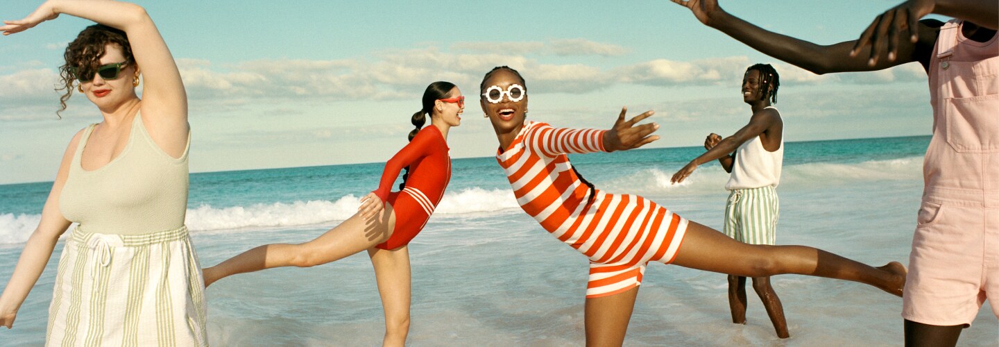 5 models dancing on a tropical beach in the summer